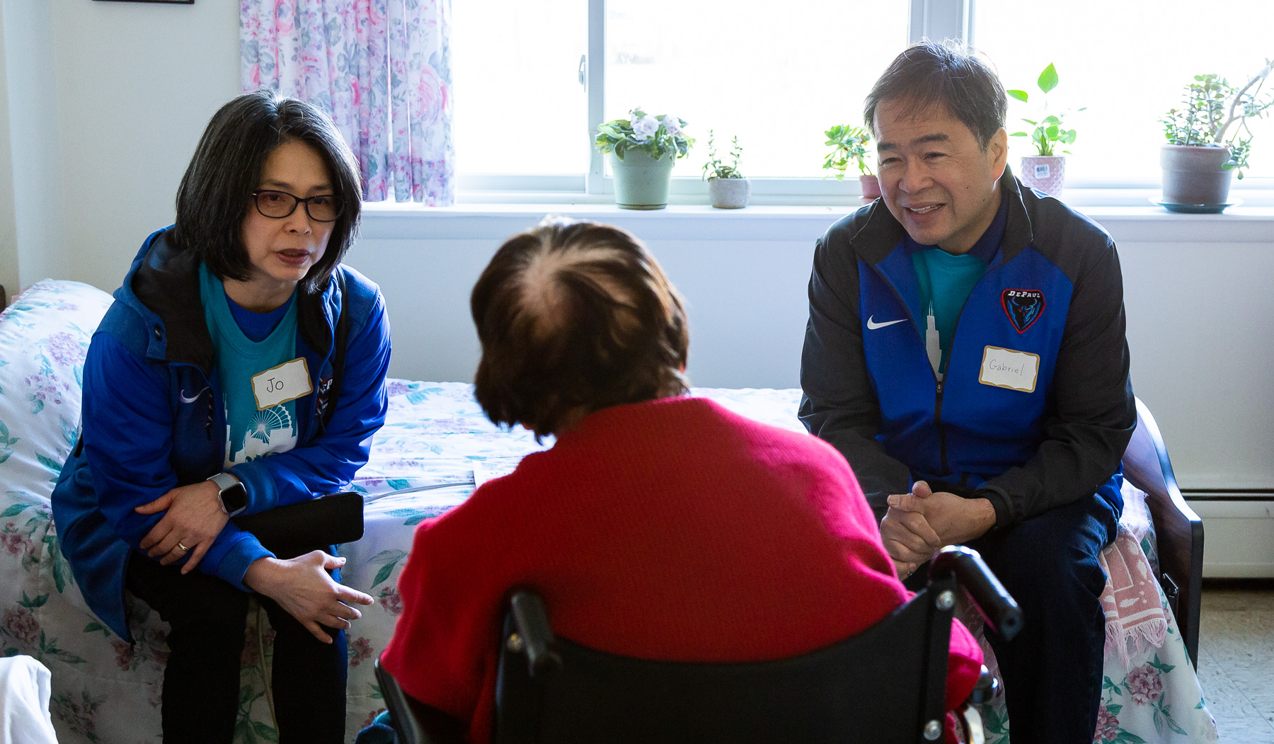 A. Gabriel Esteban, Ph.D., president of DePaul University, and his wife Josephine talk with a resident of St. Mary’s Home in the Lincoln Park neighborhood. (DePaul University/Katie Donovan)